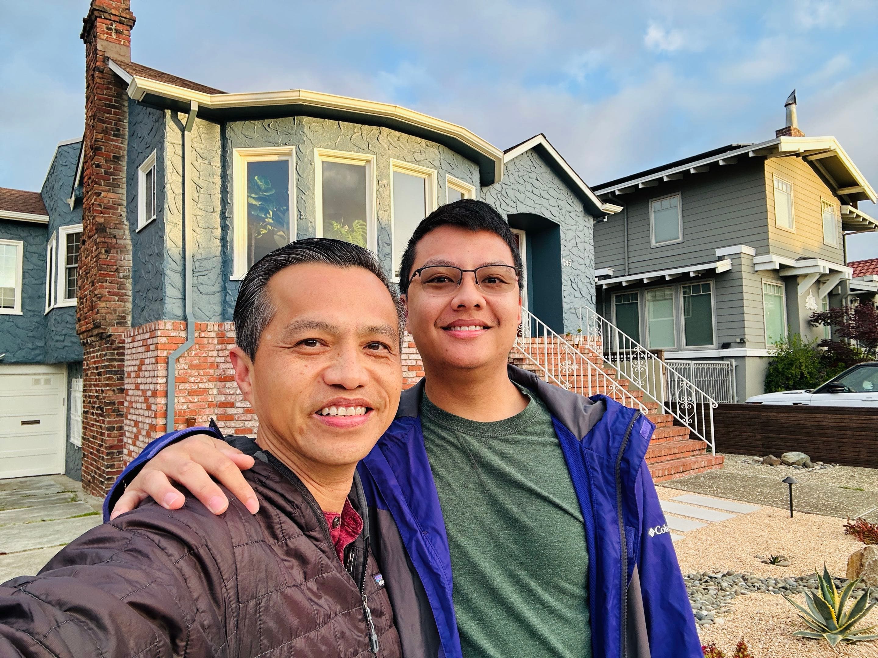 Tri Tran and his son Tyler standing together outside a home in San Mateo County.